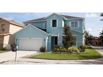 Charming two-story home with manicured lawn and attached garage at 7120 Early Gold Ln, Riverview, FL 33578