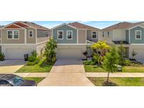 Charming two-story home with well-manicured lawn and a two car garage at 12950 Pasture Woods Pl, Lithia, FL 33547