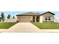 Charming single-story home featuring a spacious two-car garage, well-manicured lawn and neutral paint scheme at 1418 Bluejack Oak Dr, Seffner, FL 33584