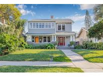 Charming two-story home features a well-manicured lawn and a welcoming front porch at 2628 2Nd N Ave, St Petersburg, FL 33713