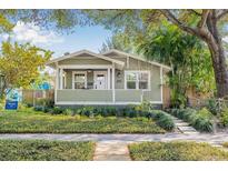 Charming single-story home with green siding, manicured lawn, and a welcoming front porch at 2710 2Nd N Ave, St Petersburg, FL 33713