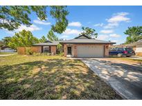 Charming single-story brick home featuring an attached two-car garage and well-maintained front lawn at 4085 37Th N Ave, St Petersburg, FL 33713