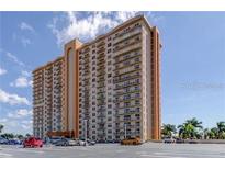 Image of a luxury high-rise condominium building with a beige facade and private balconies for each unit at 4900 Brittany S Dr # 1810, St Petersburg, FL 33715