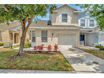 Charming two-story home featuring an attached garage and landscaped front yard at 6233 Olivedale Dr, Riverview, FL 33578