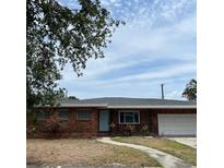 Charming single-story brick home with a well-maintained lawn and inviting front entrance at 627 E Davis Blvd, Tampa, FL 33606