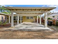 View of large carport with white pillars attached to a single-story home with the house number displayed at 6415 13Th N Ave, St Petersburg, FL 33710