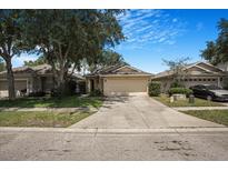 Charming single Gathering home with a well-maintained lawn and inviting curb appeal at 7031 Kendall Heath Way, Land O Lakes, FL 34637