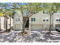 Inviting townhome featuring a two-car garage, well-manicured landscaping, and a charming facade at 736 Coral Reef Dr, Tampa, FL 33602