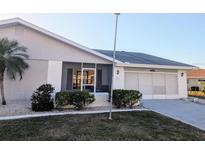 Charming single-story home with an attached garage and well-maintained landscaping at 810 Bluewater Dr, Sun City Center, FL 33573