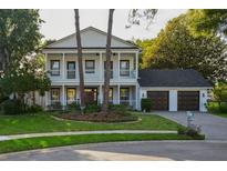 Charming two-story home with a landscaped front yard and a two-car garage at 15704 Mifflin Ct, Tampa, FL 33647