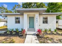 Charming single-story home featuring a stucco exterior, minimalist landscaping, and a modern, covered entryway at 1607 34Th E Ave, Bradenton, FL 34208