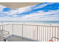 Beautiful beach view from the balcony with white metal railing and tile flooring, perfect for relaxing and enjoying the scenery at 18650 Gulf Blvd # 203, Indian Shores, FL 33785