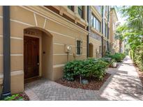 Inviting townhouse front door with brick paved walkway and lush landscaping at 2221 Soho Bay Ct, Tampa, FL 33606