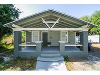 Charming bungalow with a covered front porch, gray siding, and updated gray foundation at 3515 E 8Th Ave, Tampa, FL 33605