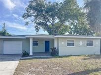 Charming single-story home featuring a well-maintained lawn, attached garage and inviting front porch at 4715 W Chapin Ave, Tampa, FL 33611
