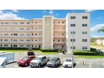Exterior of building with multiple levels, balconies, parking lot and landscaping at 5623 80Th N St # 202, St Petersburg, FL 33709