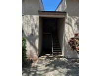 Exterior entrance to the building with stairs leading to the upper levels with the building address posted at 7506 Presley Pl # 107, Tampa, FL 33617
