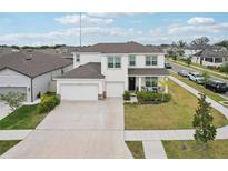 Beautiful two-story home with a three-car garage, manicured lawn and stone accents at 13055 Willow Grove Dr, Riverview, FL 33579