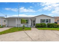 Charming single-story home featuring a well-maintained lawn, covered entry, and attached garage at 13612 Veronica Dr, Hudson, FL 34667