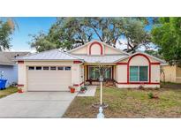 Charming single-story home featuring a well-manicured lawn and attached two-car garage at 1432 Windjammer Pl, Valrico, FL 33594