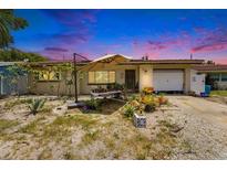 Charming single-story home with a cozy front yard featuring a lovely garden and a covered entrance at 2078 Shadow Ln, Clearwater, FL 33763