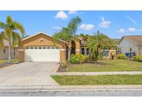 Charming single-story home featuring a well-manicured lawn and attached two-car garage at 4410 Foxboro Dr, New Port Richey, FL 34653