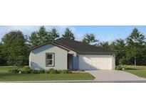 Charming single-story home featuring a two-car garage and a well-manicured front lawn with lush landscaping at 5662 Red Kite Dr, Wimauma, FL 33598