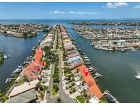 Aerial view of waterfront homes with boat docks on a clear day, providing direct access to the ocean at 813 Symphony Isles Blvd, Apollo Beach, FL 33572