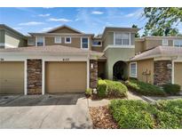 Inviting two-story townhome with stone accents, attached garage, and well-maintained landscaping at 8132 Stone Path Way, Tampa, FL 33647