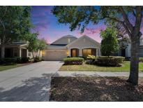 Inviting single-Gathering home featuring a well-manicured lawn and attached two-car garage at 9023 Sienna Moss Ln, Riverview, FL 33578