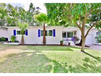 Charming single-story home with a well-manicured lawn and vibrant landscaping, showcasing curb appeal at 913 Chester Dr, Clearwater, FL 33756