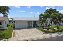 Charming single-story home with a manicured lawn, beautiful driveway, and inviting curb appeal at 9743 36Th N Way # 4, Pinellas Park, FL 33782