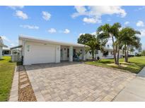 Charming single-story home with a paver driveway and lush tropical landscaping at 9743 36Th N Way # 4, Pinellas Park, FL 33782
