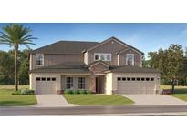 A beautifully built two-story home featuring a two-car garage, manicured lawn, and a combination of stone and siding details at 11837 Blue Diamond Trl, Parrish, FL 34219