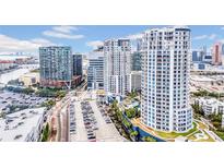 Stunning aerial view of luxury high-rise condominiums and a parking lot in an urban setting with blue skies at 1209 E Cumberland Ave # 2006, Tampa, FL 33602