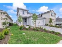 Charming two-story home with attached two-car garage, landscaped yard, and lovely gray exterior at 15918 Mulrion Blvd, Punta Gorda, FL 33982