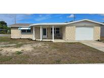 Charming single-story home featuring a unique stone facade and a cozy covered porch at 2035 Erin Dr, Holiday, FL 34690
