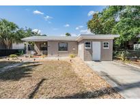 Charming single-story home with tidy front yard, sidewalk, and landscaped areas at 2111 W Grace St, Tampa, FL 33607