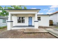 Charming single-story home featuring a welcoming front porch and light blue entry door at 2921 N 18Th St, Tampa, FL 33605