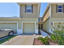 Charming townhome featuring a one-car garage and manicured landscaping at 3072 Inlet Breeze Way, Holiday, FL 34691