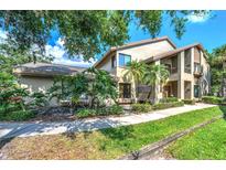 Inviting two-story home with well-maintained landscaping and a welcoming walkway at 3079 Landmark Blvd # 1608, Palm Harbor, FL 34684