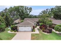Charming home with mature landscaping and a two-car garage, creating excellent curb appeal at 3268 Tanglewood Trl, Palm Harbor, FL 34685
