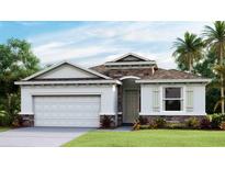 Charming single-story home featuring stone accents, a two-car garage, and well-maintained landscaping at 6761 Flint Creek Dr, Land O Lakes, FL 34638