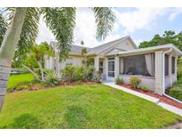 Charming home boasts lush landscaping, mature trees, and a welcoming screened-in porch for relaxing outdoors at 815 Silverthorn Ln # 0, Sun City Center, FL 33573
