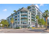 Beautiful condominium building with lush tropical landscaping and outdoor seating near the entrance at 111 N 12Th St # 1305, Tampa, FL 33602