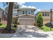 Charming two-story home features a neutral-colored exterior, brick-paved driveway, and a well-manicured lawn at 16226 Bayberry View Dr, Lithia, FL 33547