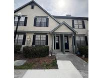 Inviting townhome with a well-maintained lawn, walkway and covered entryway at 16530 Brigadoon Dr, Tampa, FL 33618