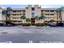 Inviting condominium building with covered parking and meticulously manicured landscaping at 2614 Cove Cay Dr # 409, Clearwater, FL 33760