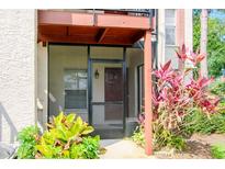 Charming screened front porch with decorative plants welcomes you to this lovely home at 3455 Countryside Blvd # 31, Clearwater, FL 33761