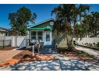 Charming home featuring a lush front yard, inviting porch, and well-maintained exterior at 451 27Th N Ave, St Petersburg, FL 33704